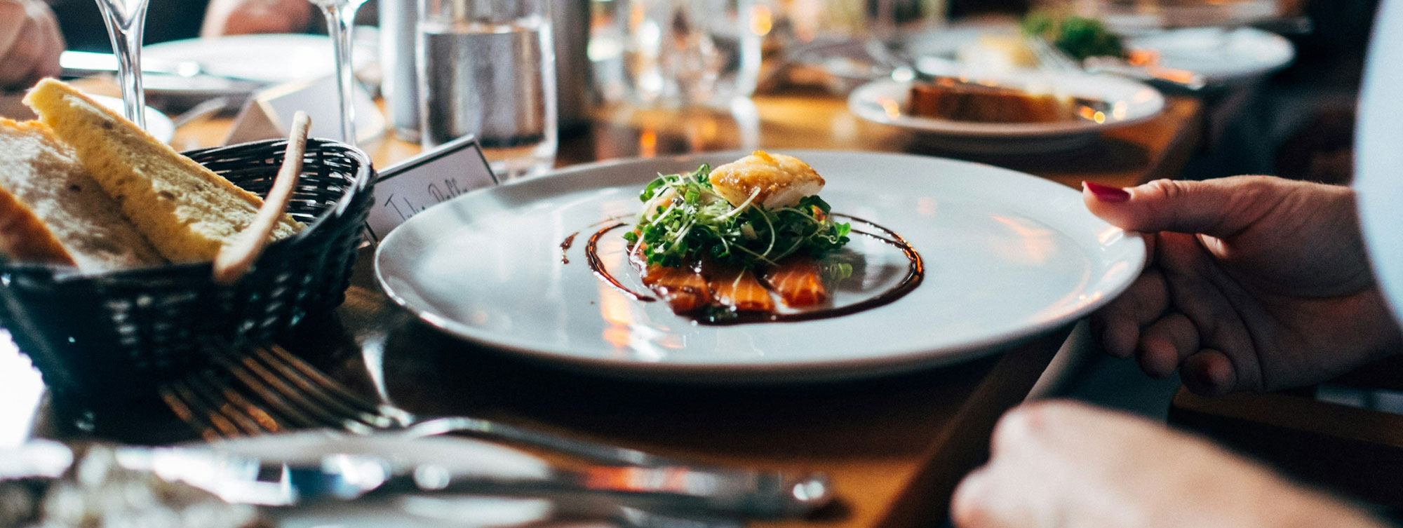 Exterior of a grand holiday cottage with outdoor furniture and lawn